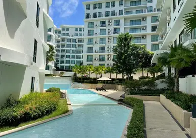 a swimming pool in front of a large building at Luxurious 5-star Apartment in Rawai Beach