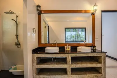 a bathroom with two sinks and a large mirror at Bua Sawan - 4 Bedrooms Pool Villa in Ban Pak Lak