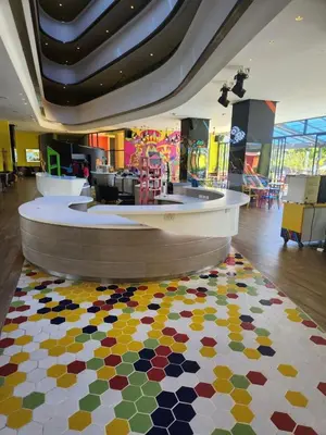 a lobby with a colorful rug on the floor at Cassia Loft Laguna Phuket Bang Tao Beach in Laguna Phuket