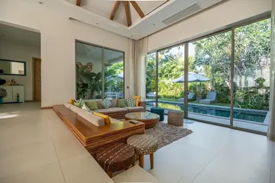 a living room with a couch and a table at Villa Allamanda 3 Bdrm Best Location Bangtao Beach VVPHU88 in Phuket