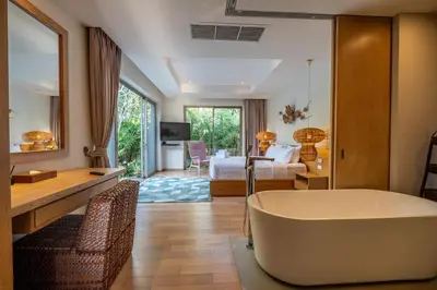 a large bathroom with a tub and a bedroom at Villa Allamanda 3 Bdrm Best Location Bangtao Beach VVPHU88 in Phuket