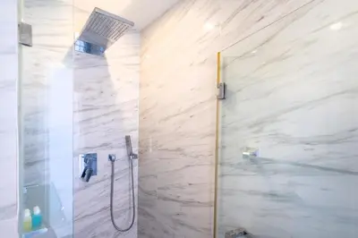 a shower with a glass door in a bathroom at Prime Location Kamala Ocean View Suite OCN C64 just 450m to the Beach in Kamala Beach