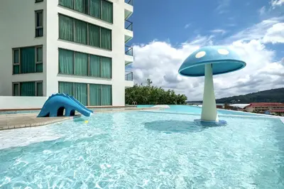 a swimming pool with a blue mushroom in a building at Kamala Ocean View 2BR Apartment OCN C35, just 5 min walk to the Beach in Kamala Beach