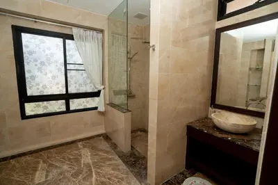 a bathroom with a sink and a glass shower at Laguna Luxure Private Pool Villa in Layan Beach