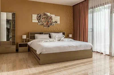 a bedroom with a large bed and a large window at Villa Belloro Bang Tao 3BR East Residence in Ban Pak Lak