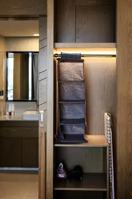 a walk in closet with towels and a sink at Suite Aura 1BR PoolsGyms Shuttle to Nai Harn in Rawai Beach
