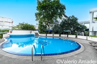 a large blue swimming pool in a building at OMNIAPHUKET - Patong Tower - Premium 3 Bedrooms Apartment in Patong Beach