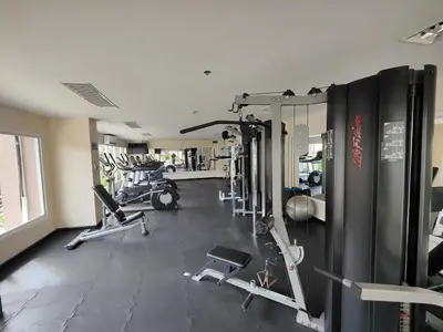 a gym with several treadmills and machines at OMNIAPHUKET - Patong Center Pool Gym Near Bangla Road in Patong Beach
