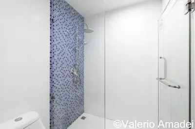 a bathroom with a glass shower with a toilet at OMNIAPHUKET - Pool access 3 bedrooms apartment in Patong Beach