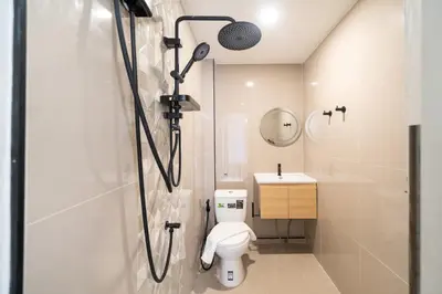 a bathroom with a shower with a toilet and a sink at Wink 3 Patong Beach Phuket sleep 8 in Patong Beach