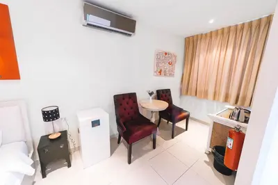 a room with two chairs and a table in it at Patong Condotel Penthouse 2 bedroom in Patong Beach