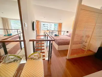 a room with a balcony with a bed and a room with a mirror at Patong Penthouse 1 bedroom in Patong Beach