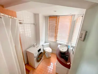 a small bathroom with a toilet and a sink at Patong Penthouse 1 bedroom in Patong Beach