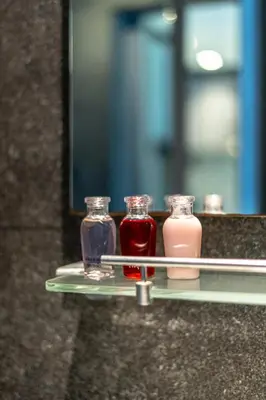 a shelf with three glass bottles on it at Suite Ruse 1BR Rooftop Pool ViewCitygate Kamala in Kamala Beach