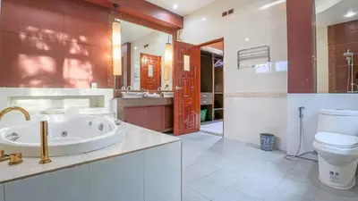 a bathroom with a tub and a toilet and a sink at Sundrenched Oasis 7bed pool villa heart of Phuket in Kathu