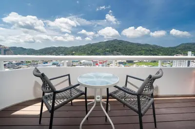 a table and two chairs on a balcony with a view at Apartment with jacuzzi - Patong Tower by lofty in Patong Beach