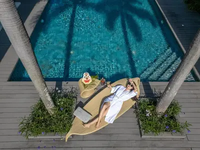 a woman laying in a hammock next to a swimming pool at Villa Marina Cape Yamu Luxury 6 Bedroom Seaview Villa, Free Breakfast, Airport Pickup and Drop-off, Servant in Ko Lek