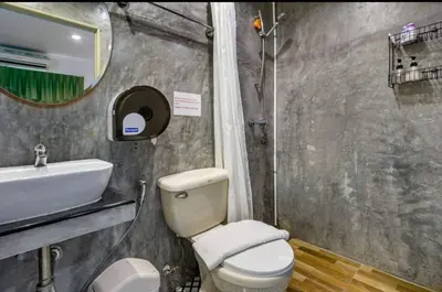 a bathroom with a toilet and a sink at La Casa Residencies in Patong Beach