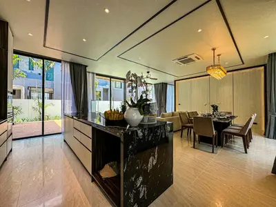 a kitchen and dining room with a table and chairs at The Ozone Luxury Villas Phuket in Laguna Phuket