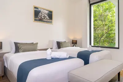 three beds in a room with a window at The Exclusive Sky D2 \u8c6a\u534e4\u5367\u5ba4\u6d77\u666f\u522b\u5885 \u79c1\u4eba12m\u65e0\u8fb9\u6d77\u666f\u6cf3\u6c60 \u6bcf\u65e5\u6e05\u6d01 in Kamala Beach