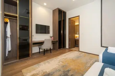 a hotel room with a desk and a bedroom at The Exclusive Sky D2 \u8c6a\u534e4\u5367\u5ba4\u6d77\u666f\u522b\u5885 \u79c1\u4eba12m\u65e0\u8fb9\u6d77\u666f\u6cf3\u6c60 \u6bcf\u65e5\u6e05\u6d01 in Kamala Beach