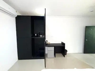 a room with a black wall and a desk at Patong Easy Life 1 in Patong Beach