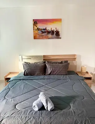 a bedroom with a bed with a towel on it at Villa Seaview Patong in Patong Beach