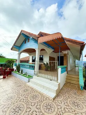 a small house with a blue roof at Villa Seaview Patong in Patong Beach