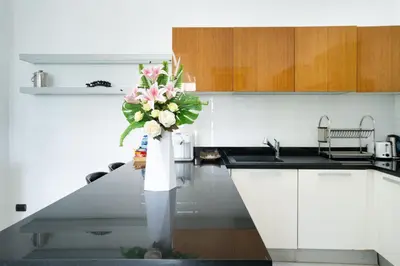 a kitchen with a vase of flowers on a counter at Sirirat Sea-view Villa in Patong Beach