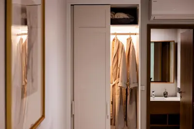 a closet with a door and a sink in a bathroom at Private garden Laguna beachside 150 m Bangtao in Bang Tao Beach