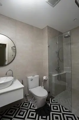 a bathroom with a toilet and a sink and a shower at ME5 Halo 2-bedroom ВатСaп66935B2I976 вид на бассейн in Nai Yang Beach