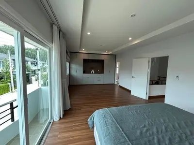 a bedroom with a bed and a large window at Supalai Rent BANG TAO PHUKET in Phuket
