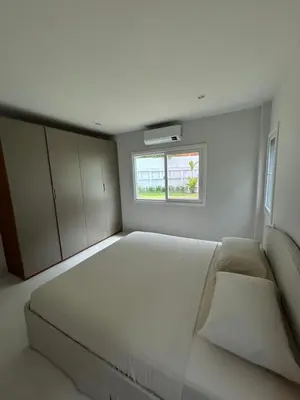 a bedroom with a large white bed with a window at Supalai Rent BANG TAO PHUKET in Phuket