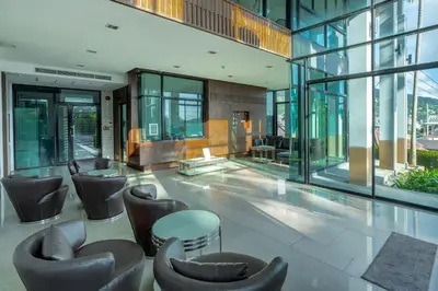 a lobby with chairs and tables in a building at Sea view apartment in Phuket in Patong Beach
