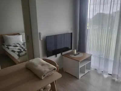 a small living room with a television and a bed at Sky Park Laguna Residences F5 in Laguna Phuket