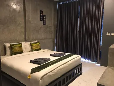 a bedroom with a bed with towels on it at Finlay Cottage Aonang in Ban Khlong Haeng