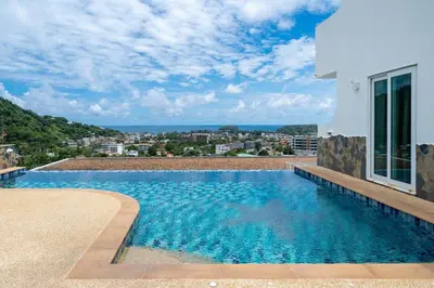 a swimming pool on the side of a house at Kata Ocean View I05 in Karon Beach