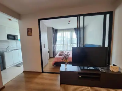 a living room with a television and a bedroom at cen 1 bed room859 in Ban Rangeng