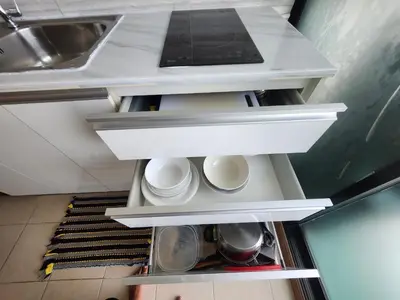 an open refrigerator with white shelves in a kitchen at cen 1 bed room859 in Ban Rangeng