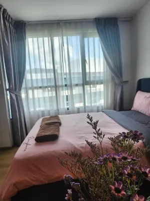 a bedroom with a bed and a large window at cen 1 bed room859 in Ban Rangeng