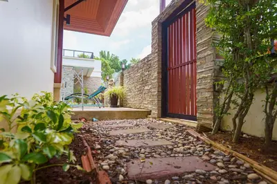a garden with a stone walkway in front of a building at Villa with Private Pool in Rawai in Rawai Beach