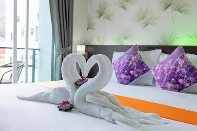 two swans made out of towels on a bed at The Chic Patong Hotel in Patong Beach