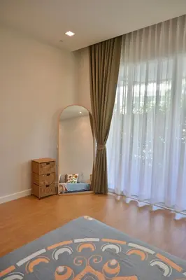 a living room with a mirror and a dresser at The Pelican Suite Residence Condo Klong Muang, Krabi in Klong Muang Beach