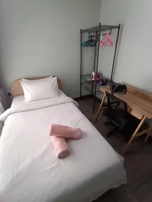 a pink towel laying on top of a bed at Centrio 2 Bedrooms Condos in Town-Central Phuket in Ban Rangeng