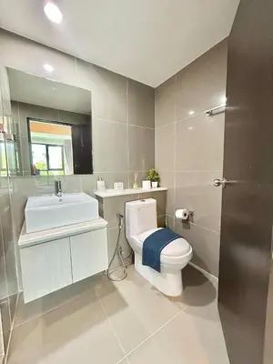 a bathroom with a white toilet and a sink at 1 Bedroom Condos Close to Shopping Malls in Ban Rangeng