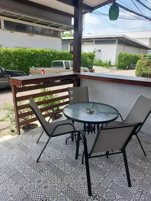 a table and two chairs on a patio at Smile House Apartment 24 in Karon Beach