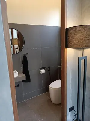a bathroom with a toilet and a sink and a mirror at New 2 BR Villa Nai Thon in Nai Yang Beach