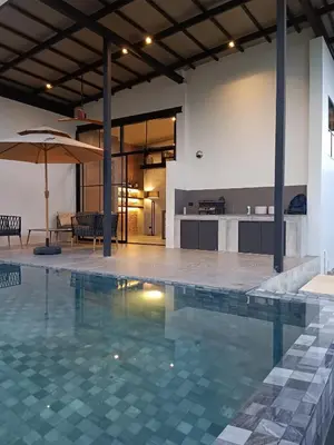a swimming pool in a house with a kitchen at New 2 BR Villa Nai Thon in Nai Yang Beach