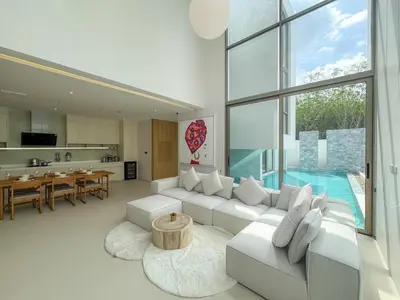 a living room with a white couch and a pool at Luxurious 3-Bedroom Villa with Private Pool Lux Pride 4 L10 Phuket in Bang Tao Beach