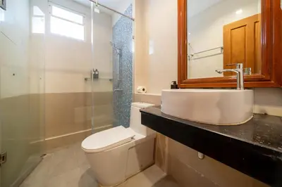 a bathroom with a toilet and a sink and a shower at 7BR Grand Pool Villa in heart Patong in Patong Beach